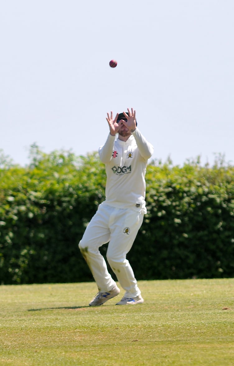 Devon Cricket League A Division. Abbotskerswell versus Kilmington. The safe hands of Abbots' Charlie Hill waiting for the high ball that Sam Cuconits hit into orbit off a ball hurled down by Noah Tobias