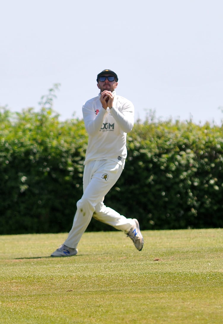 Devon Cricket League A Division. Abbotskerswell versus Kilmington. The safe hands of Abbots' Charlie Hill catch the high ball that Sam Cuconits hit into orbit off a ball hurled down by Noah Tobias