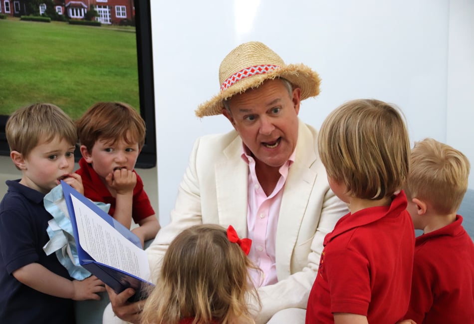 <p>Hugh Bonneville, star of the Paddington films, reads an excerpt from Michael Bond’s tale to pupils at Highfield and Brookham Schools</p>