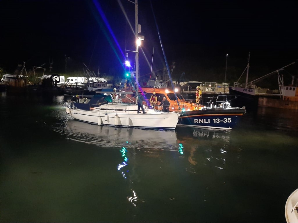 Lifeboat with recovered yacht in Peel marina