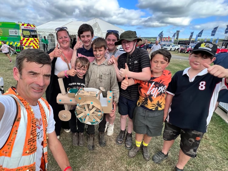 Nick Corston and the Boiling family and friends with a cardboard traction engine