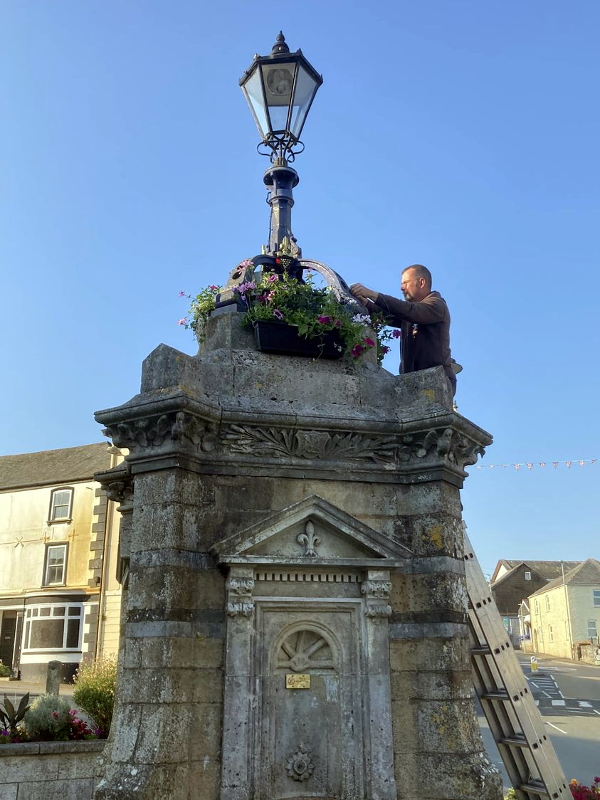 VOLUNTEERS Rick and Alfie were among the helpers getting more than 100 hanging baskets up around Liskeard’s