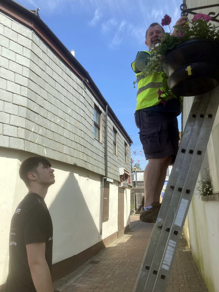 VOLUNTEERS Rick and Alfie were among the helpers getting more than 100 hanging baskets up around Liskeard’s