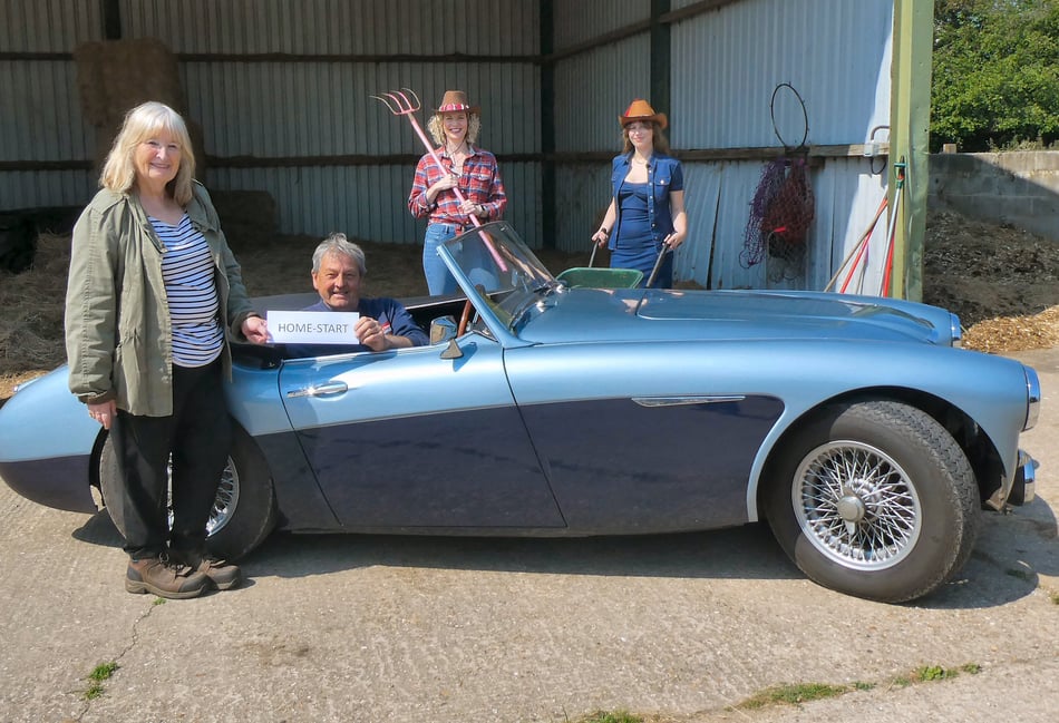 <p>Sally Stewart receives Bill Rawles’ sponsorship watched by fundraisers Suzanne and Charlotte Rogers</p>