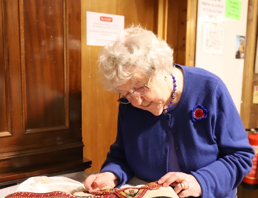 <p>91-year-old Freda working on Haslemere Museum's textiles collection</p>