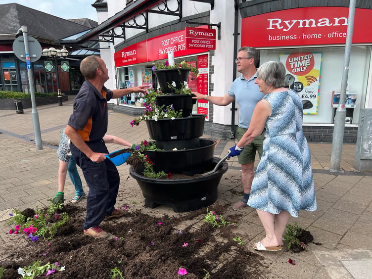 Volunteers were in high spirits as they fixed up the destroyed planter