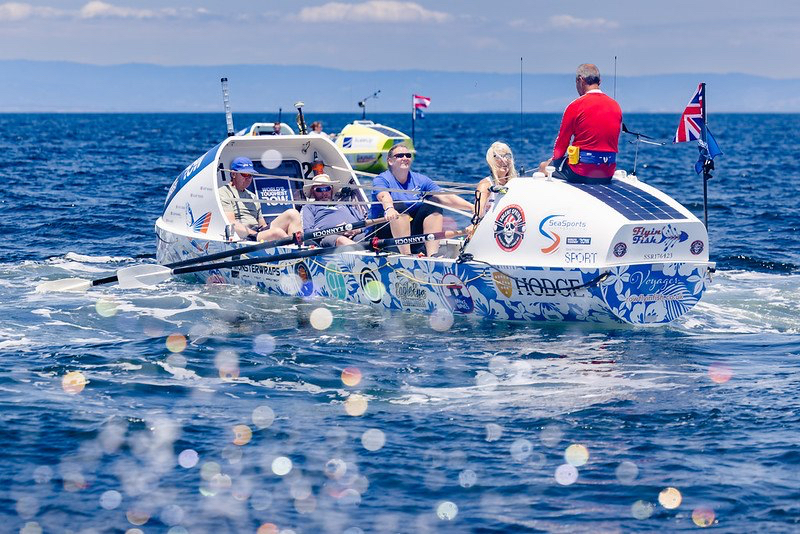 The calm before the storm as Team FlyinFish soak up some sunshine, above, and below leaving
Monterey Harbour (left) to start the Pacific row, and the crew with Elaine, right, beside Huw.