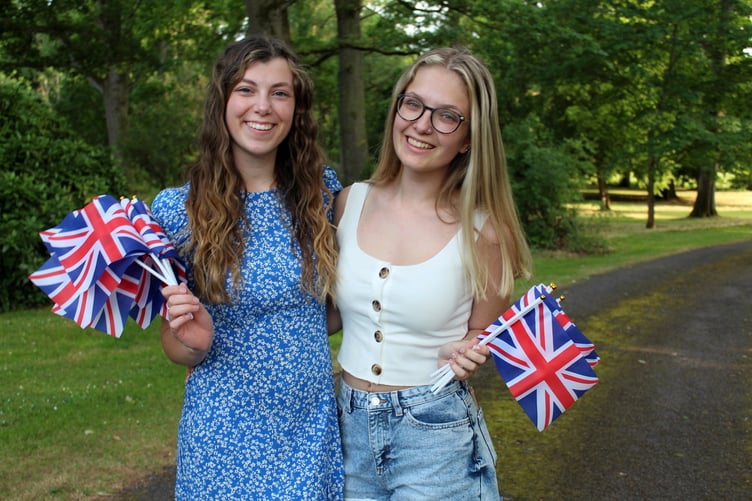 Jess Ladd and Izzy Haslam giving away flags and programmes for the audience to use, especially during the Proms songs. SR 8130