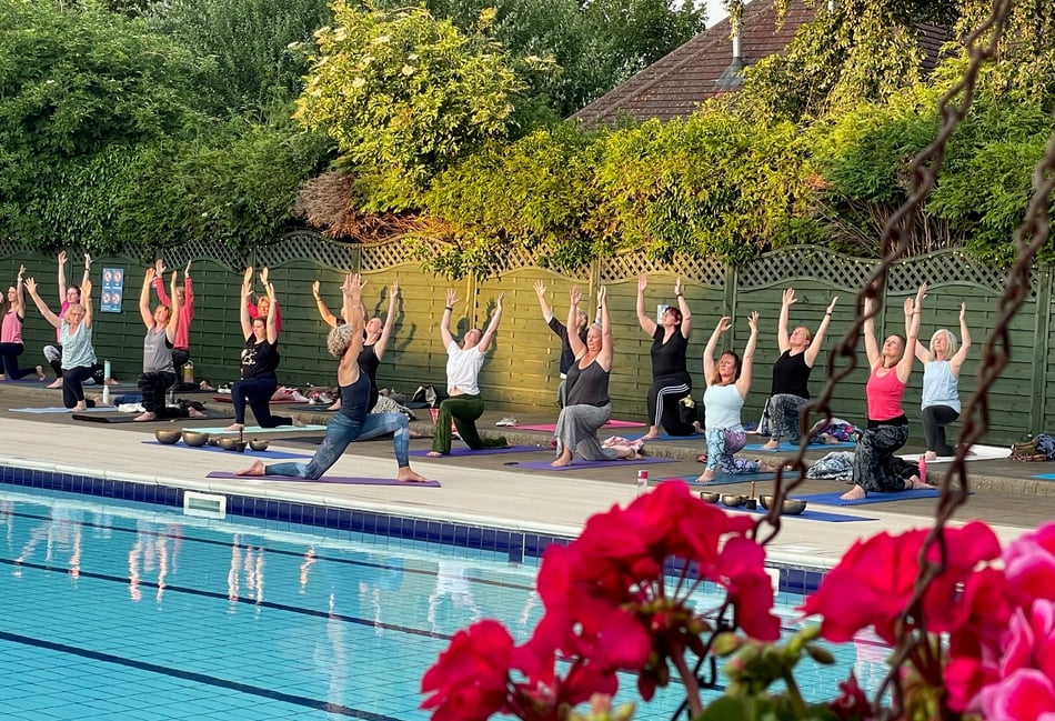 <p>Yogis salute the sun at Petersfield Open Air Swimming Pool – sessions are run regularly by Wild Nest Yoga Studio</p>