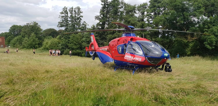 Youngsters wait near the Devon Air Ambulance to see how their friend is.