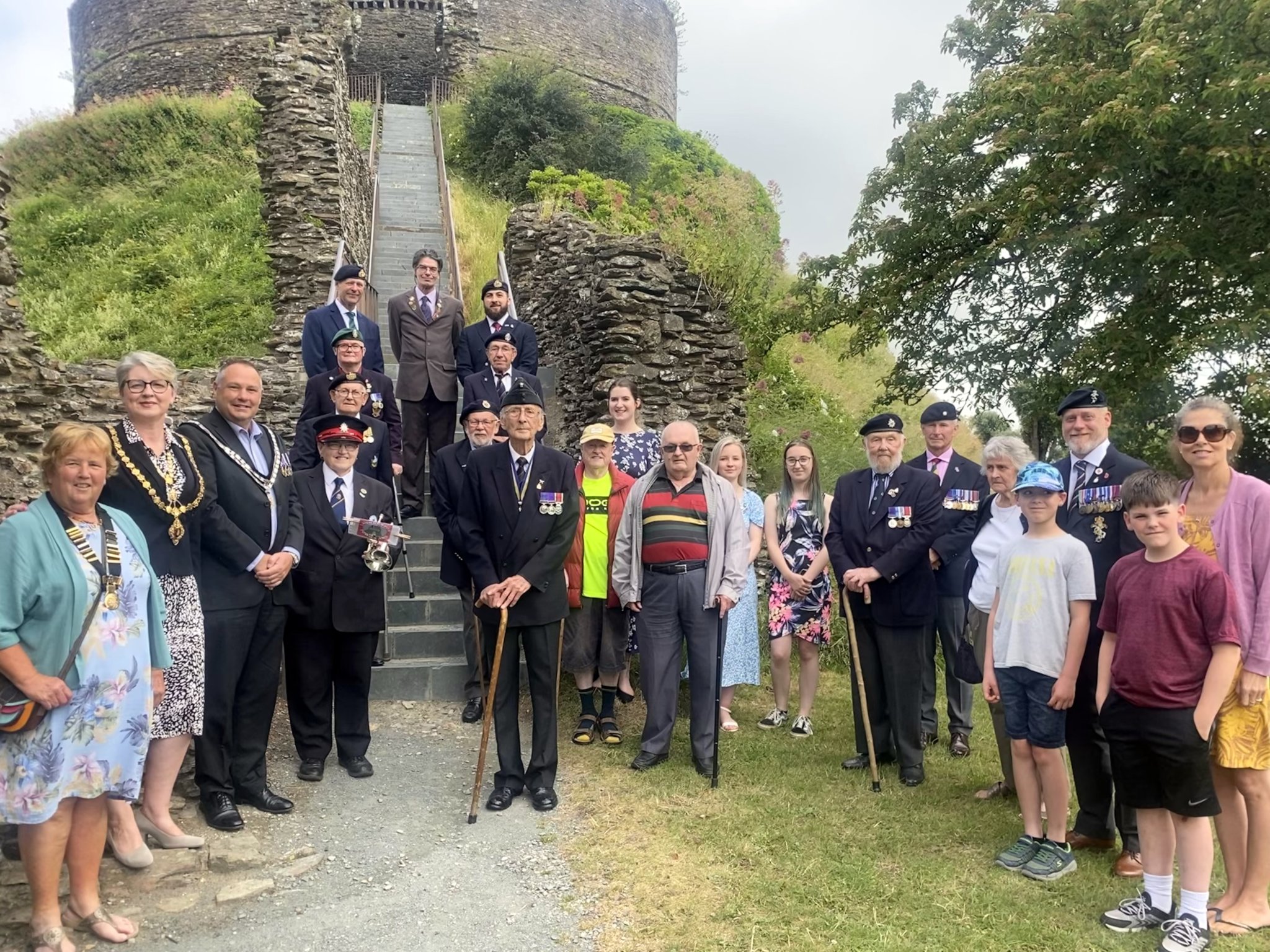 Members of Launceston Royal British Legion, Anne Brown of Launceston Town Band on the bugle and the town’s Mayor Cllr Helen Bailey and consort Adrian Bailey, are pictured at the base of the Castle ahead of the traditional Armed Forces Day flag was raising