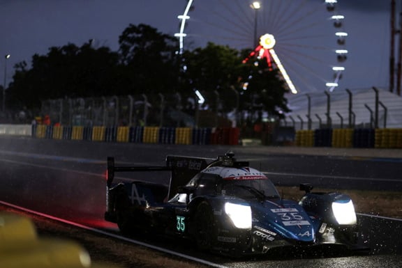 The Alpine car racing through the night at Le Mans
