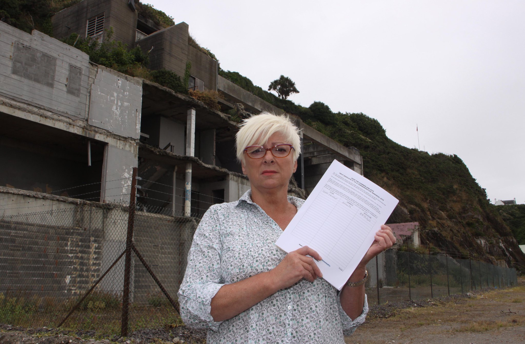 Tina Brennen on the Summerland site with her petition to turn the Summerland site into a memorial Garden for the victims of the fire Douglas promenade.