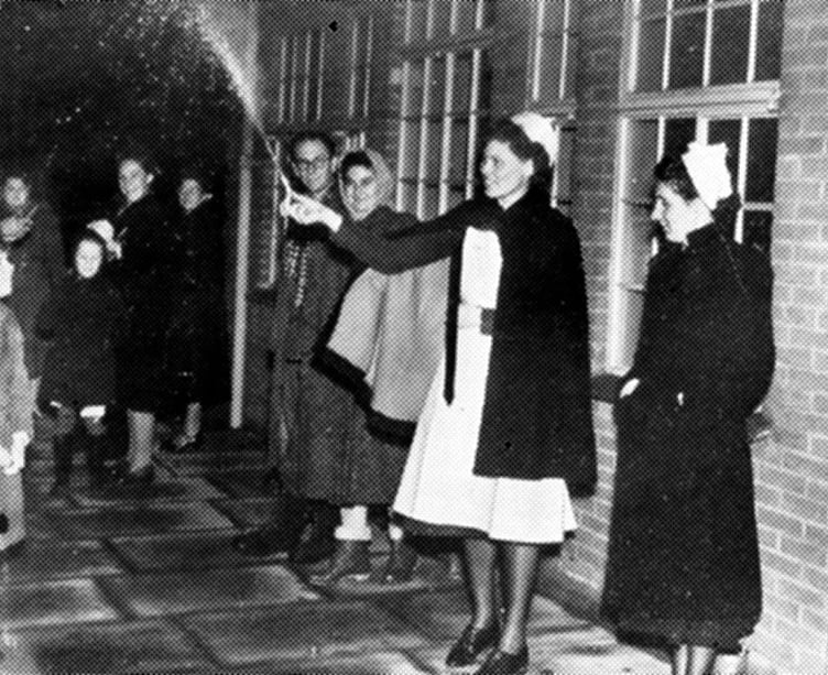 A nurse holds a small firework to celebrate 1949’s Guy Fawkes Night at Trimmer’s Hospital in Farnham