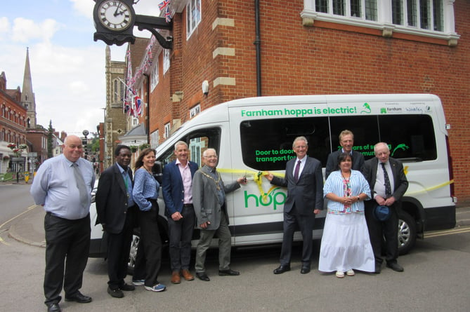 Representatives from Farnham Town Council and hoppa celebrate the launch of a new electric bus which will service the Farnham area                               