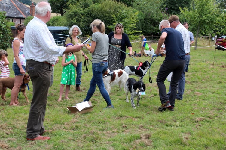 One dog pleased with its prize card, left is Steve Hodder. SR 8249