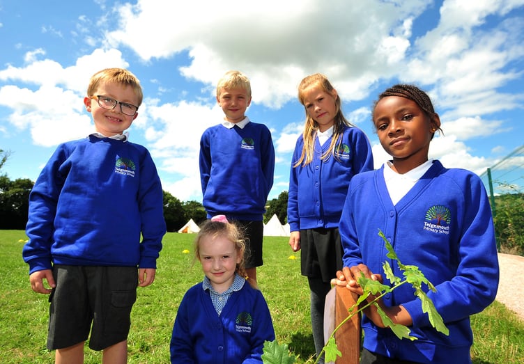 Teignmouth Primary School. 50th anniversary tree planting. Showing off their new Teignmouth Primary School jumpers - pupils Rory, Lottie-Mai, Freddie, Erin and Audrey.