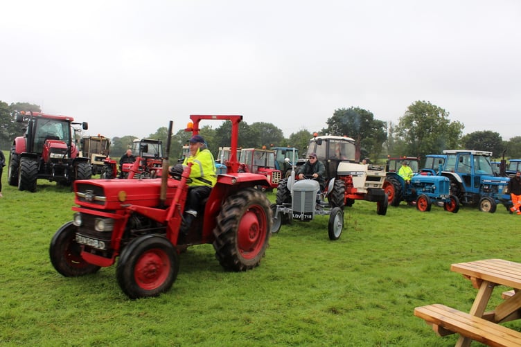 Older tractors leaving the field in the rain for the run. SR 8558