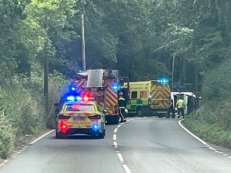 The accident scene with the white van on its side. AQ 3535