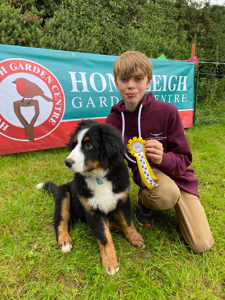 Buddy the 15 week old Burmese mountain dog and his owner Reece Leeson from St Giles on the Heath won 3rd place in the handsomest fella class