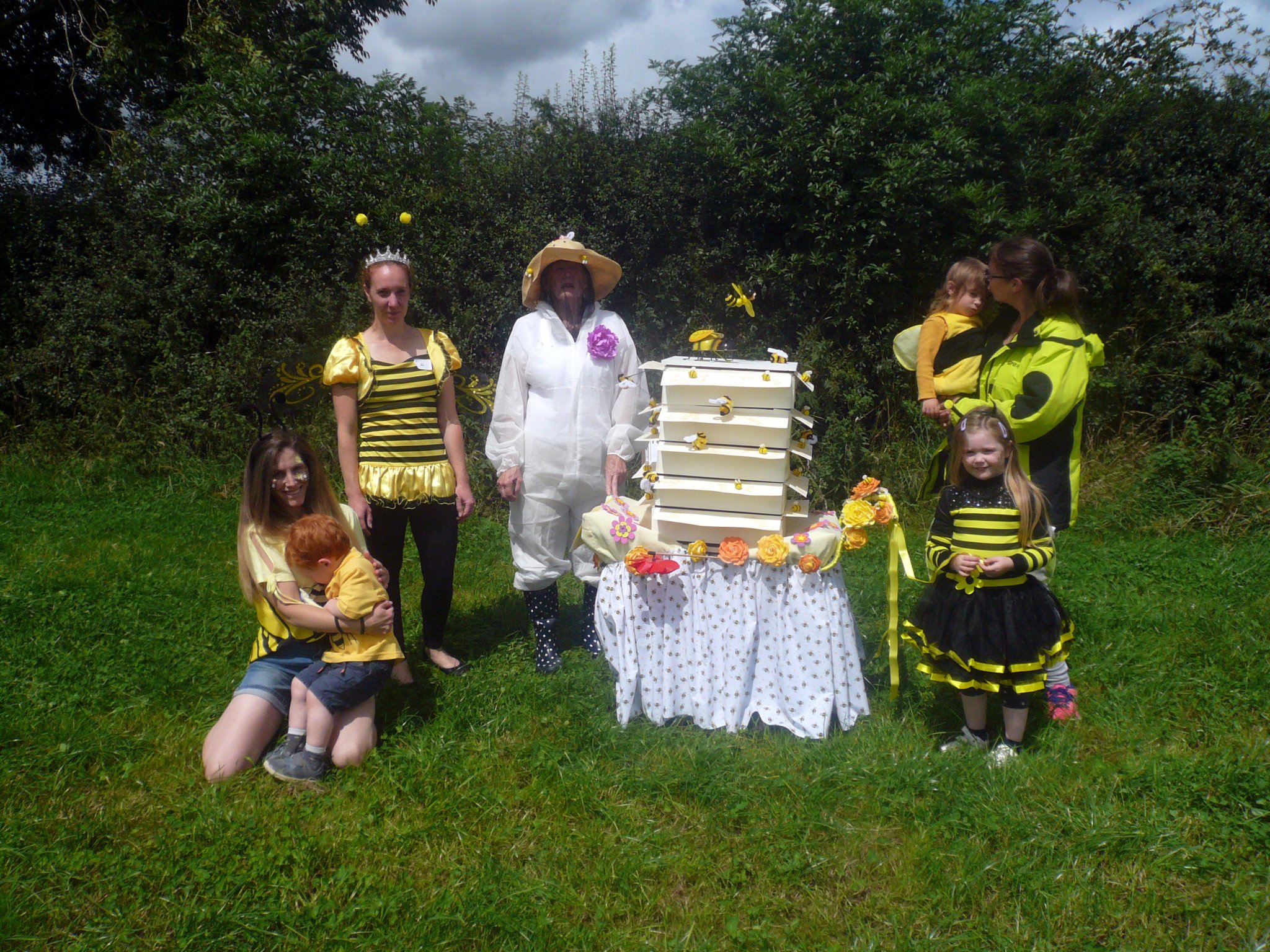 Queen bee Mel Kilby and beekeeper Jude Pile with a few of their colony representing The Little Links Group
