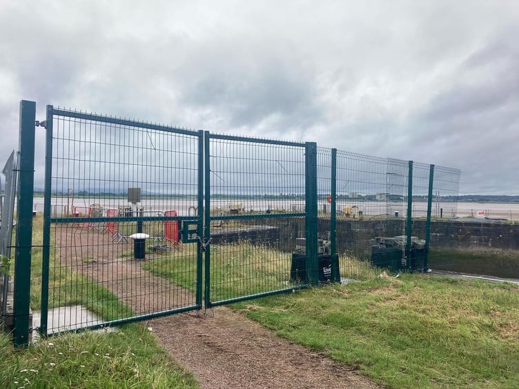 The 'temporary' fence which has been erected to prevent people from accessing the piers
