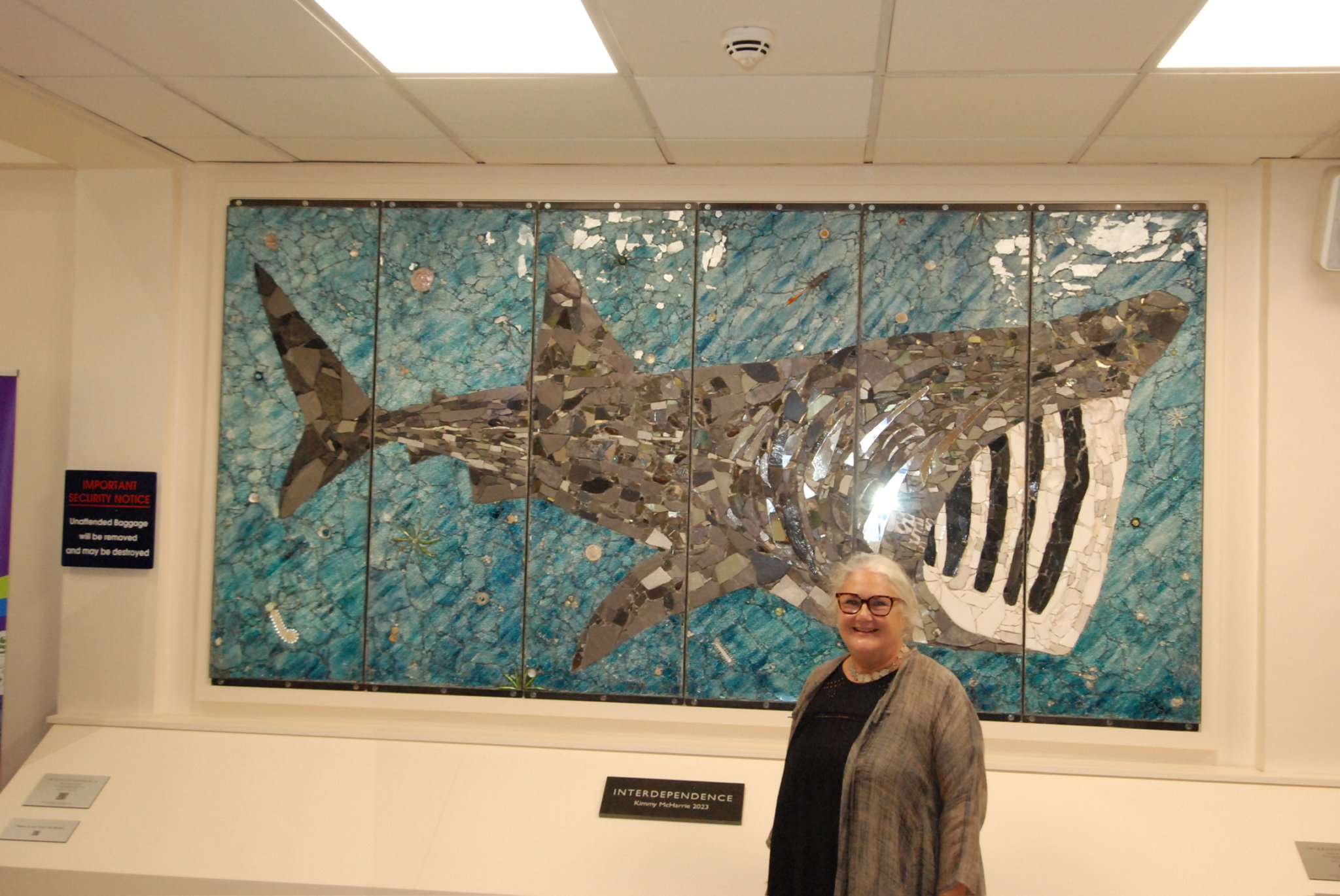 Artist Kimmy McHarrie with the giant basking shark mosaic which has been unveiled at Ronaldsway as Culture Vannin celebrates its 40th anniversary. Below, a close up