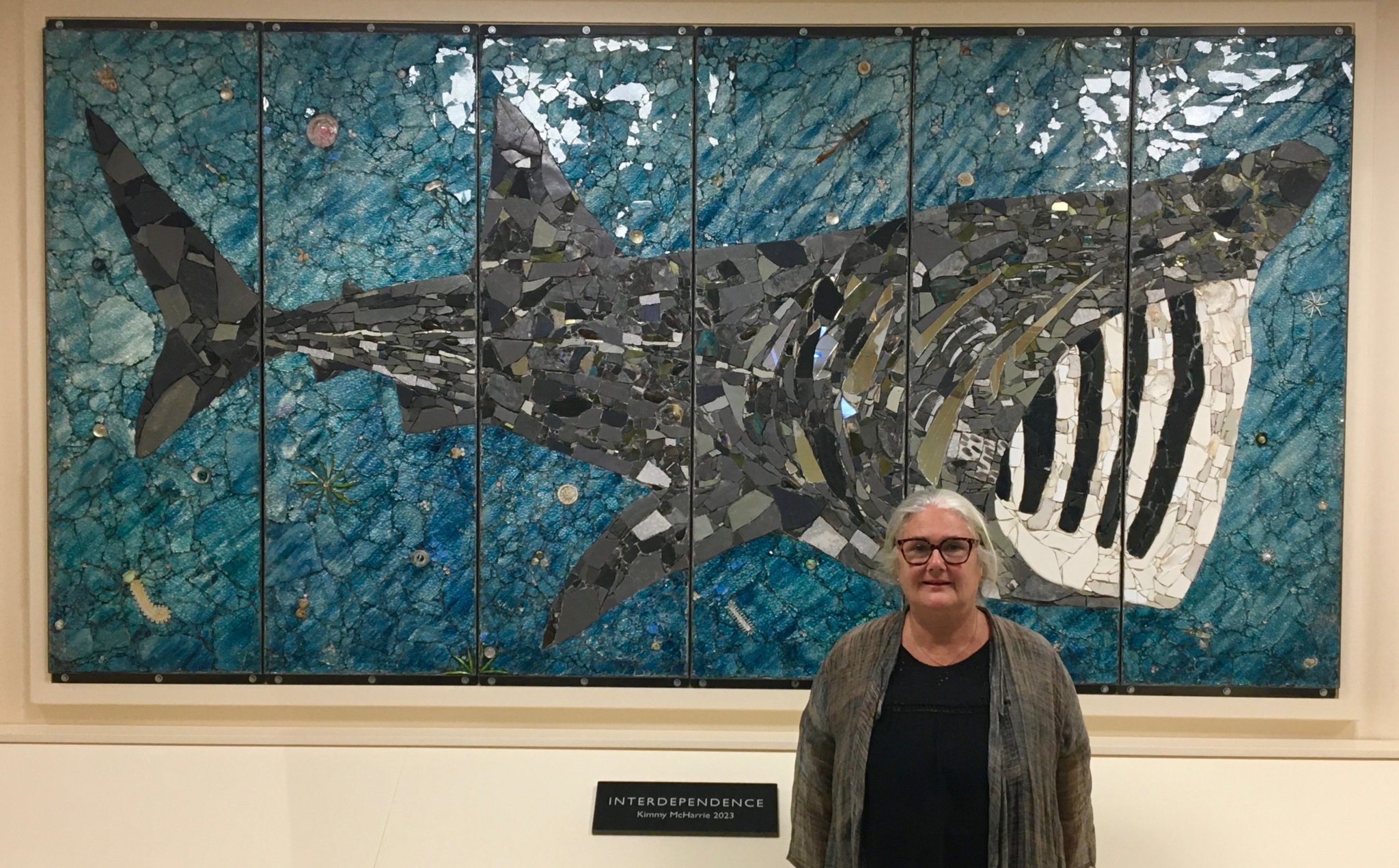 Artist Kimmy McHarrie with the giant basking shark mosaic which has been unveiled at Ronaldsway as Culture Vannin celebrates its 40th anniversary. Below, a close up