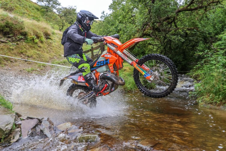 Sion Wright lifts a wheel through the first river crossing