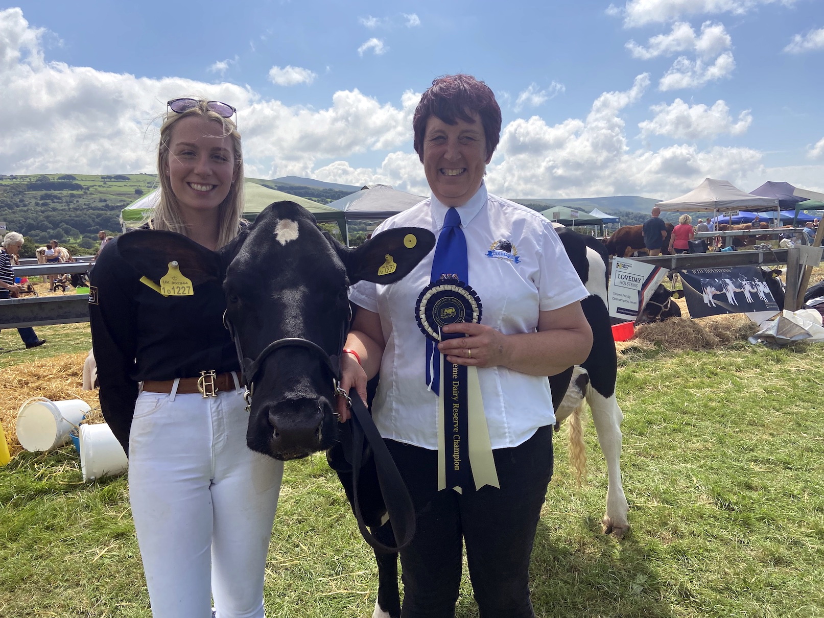 Above, Abbi Marshall, left, and Tracy Rockett of Bridestowe with their pedigree British Friesian Greenway BombardierBillie Jean which won champion any other dairy breed; below, Wilber the ram lamb  with his fan club, Eliza Davie, four, left, Evie Hutchings, six, and Henry Davie, two.
