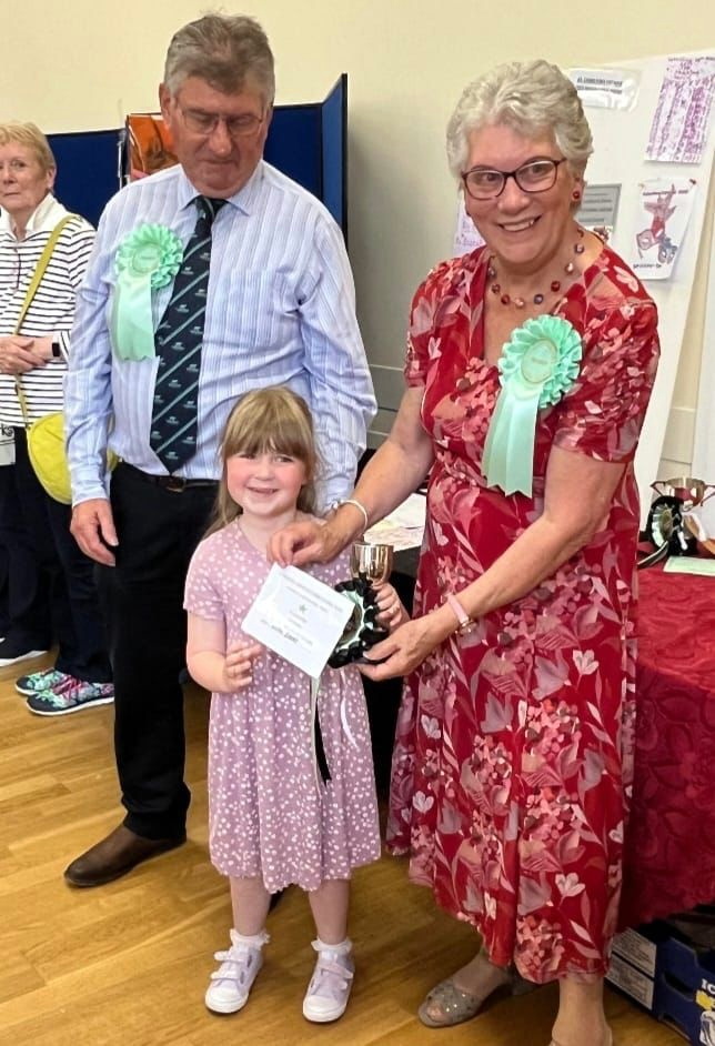 Lillie Dodd receiving the cup for most points in the handicraft for under four year olds