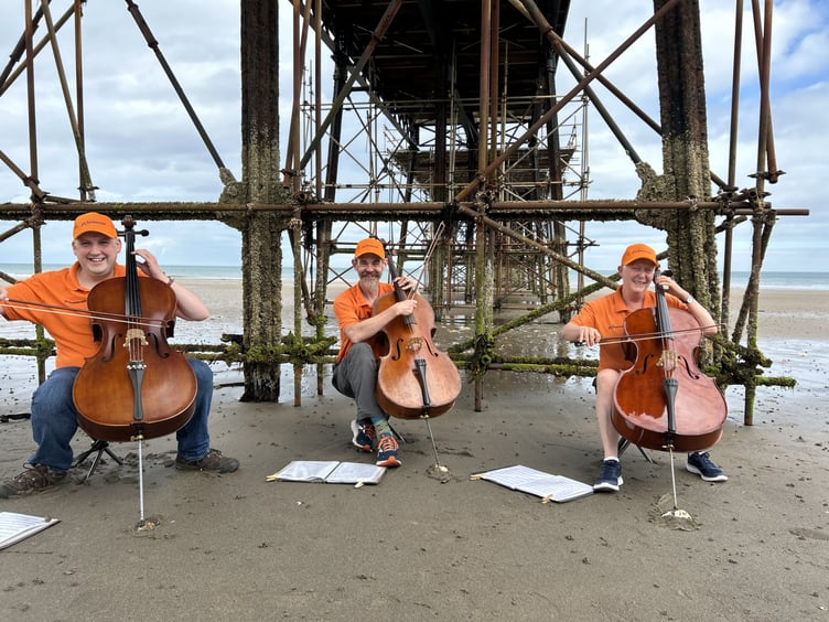 Jeremy Dawson, James Rees and Clare Wallace performing under Ramsey Pier