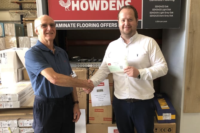 Alton Men's Shed chairman Gordon Anderson is presented with a cheque by Howdens branch manager Andy Barnes, July 25th 2023.