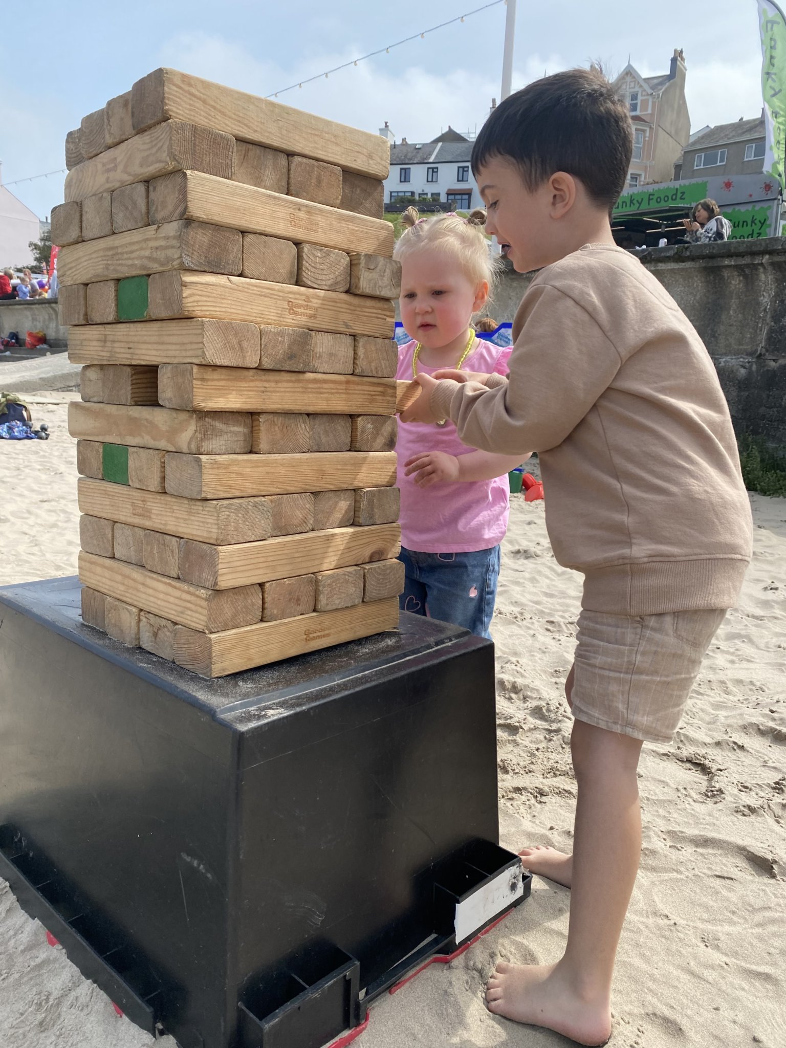 Xavi Kahzrajie, five, and Lottie Gilmore, two, play giant Jenga Photo: Jackie Darbyshire
