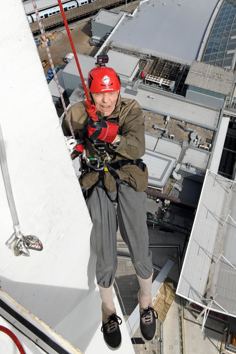 PETER WALKER SPINNAKER ABSEIL 
SPINNAKER TOWER, PORTSMOUTH, HAMPSHIRE
ENGLAND
AUGUST 2023
A 92-year-old Hampshire man undertook a charity abseil in memory of his journalist son who died in March of this year   
Hampshire's Peter Walker navigated his way down Portsmouthâs Spinnaker Tower accompanied by a professional abseiler to honour his son Jon who for many years had been the Chief Reporter at the Petersfield Post, Jon, who was 64, died just weeks after being diagnosed with terminal cancer
The Spinnaker Tower, known as 'The Sail of The Solent' is a 170 metre high observation overlooking the redevelopment of Portsmouth Harbour and the Gunwharf Quays retail complex below as well as offering a 'bird's eye view' of the adjoining Naval Base and across The Solent to the Isle of Wight 
During the summer months many people raise money for charities by experiencing the 100 metre descent and its associated adrenaline rush, but not many are 92 years of age ! 
Mr Walker Senior is aiming to raise money for Fitzroy, a charity often covered by his son which provides a range of services for adults with learning disability, autism and similar conditions.  Mr Walker, who is partially disabled and needed his doctorâs approval to undertake the challenge, said âMy son Jon was a legend because he loved Petersfield and its people and worked hard for them, for me, he is an inspiration....''I am self-sponsoring an abseil from the Spinnaker Tower to raise funds for, and to raise the profile of Fitzroy ''
Peter.....don't look down ! 
(Photo by Malcolm Wells)
 
Standard reproduction rates apply, contact Malcolm Wells to arrange payment - Mobile: 07802-217-569 
malcolmrichardwells@gmail.com