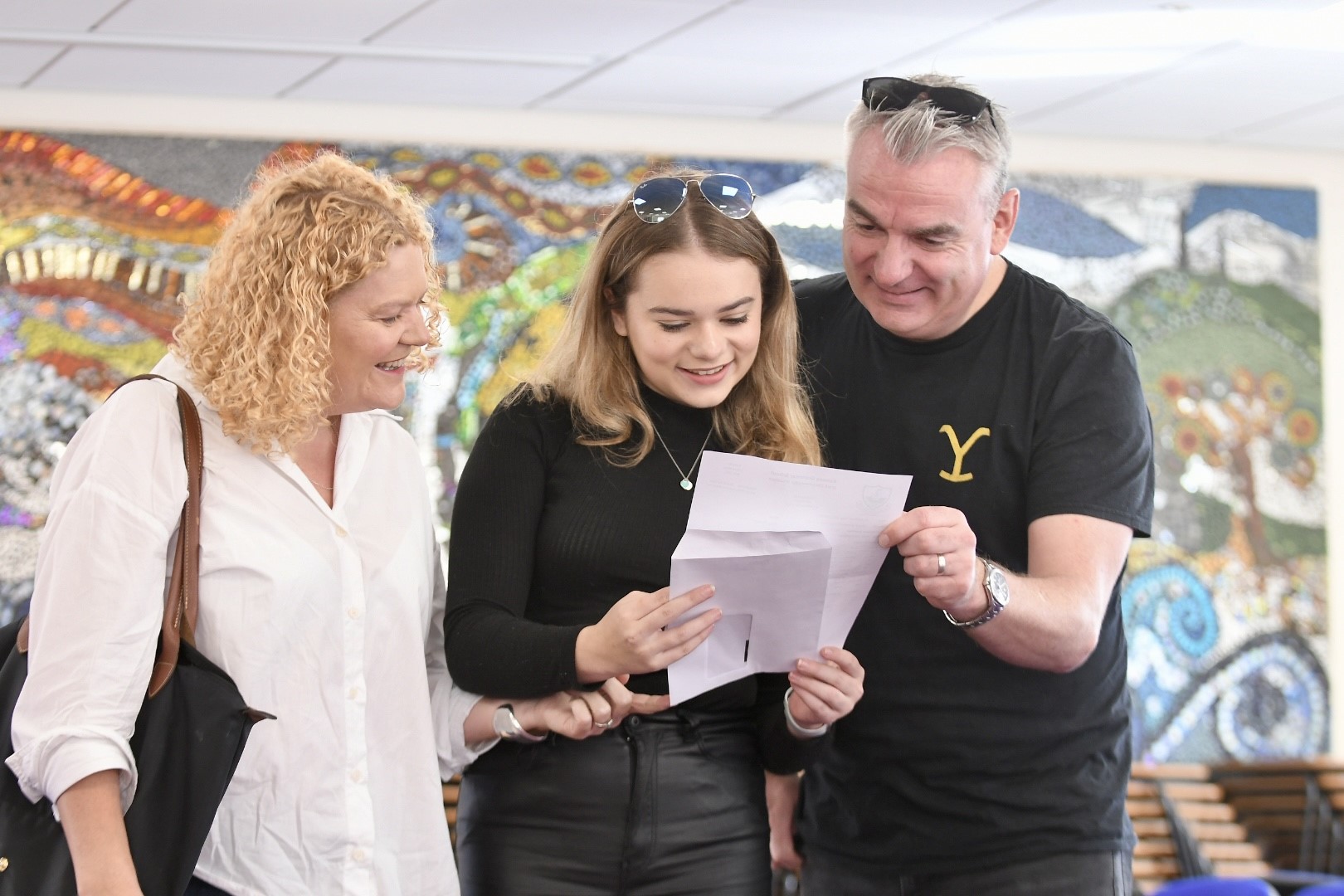 Daisy Goodby opening her GCSE results with her parents