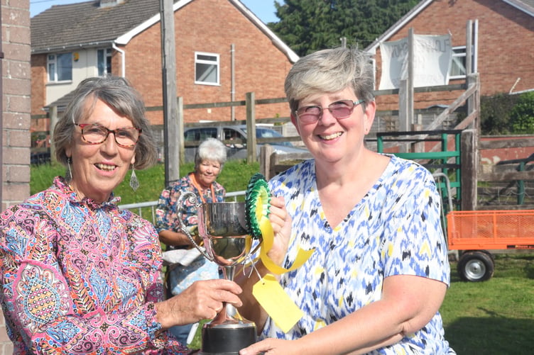 Trudi Breadman (right) is presented with the Len Preest Cup for a collection of six vegetables.