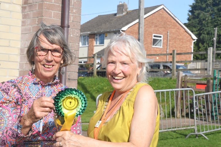 Show president Diana Standing presents the A B Harrison Cup for yield of potatoes to Helen Esplin