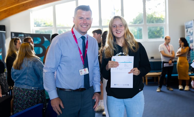 Mr Crane (head of Sixth Form) and Emily McKay receiving results