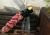 Giant dragonfly as church celebrates flowers and nature