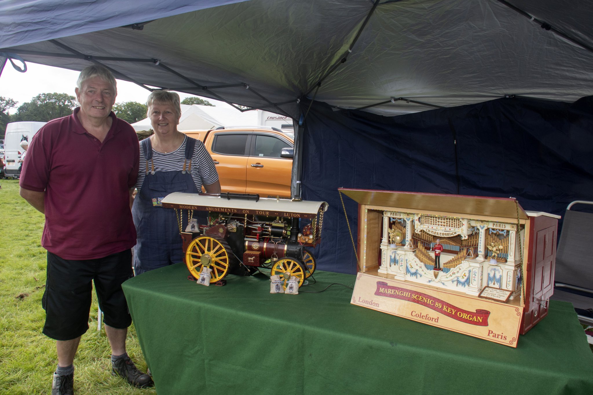 Ian and Suzanne Hannam of Broadwell with a 1.5 inch scale model of a traction engine and organ which Mr Hannam restored.