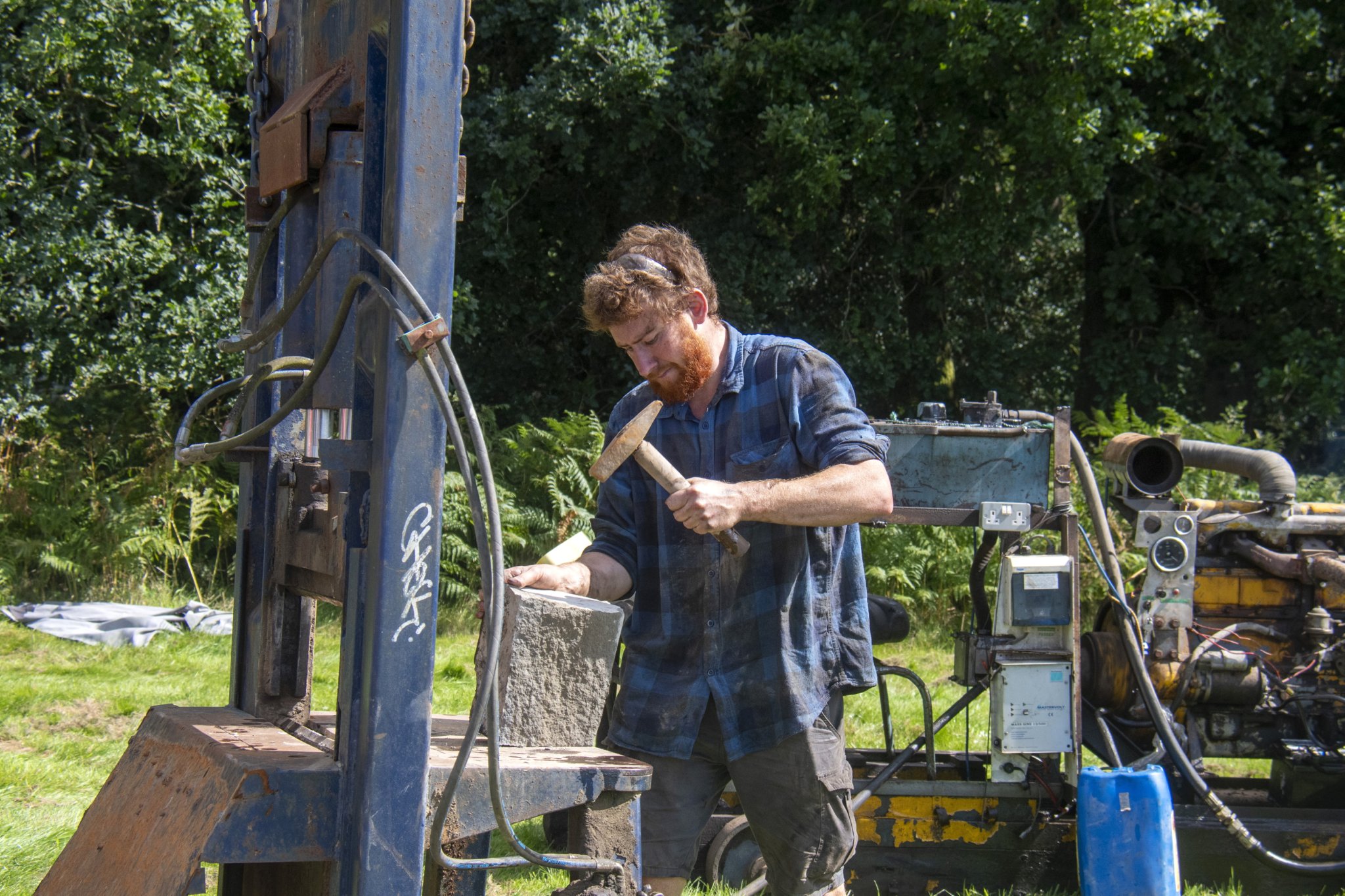 Harry Cole of Monument Quarry demonstrates a stone cutting machine.