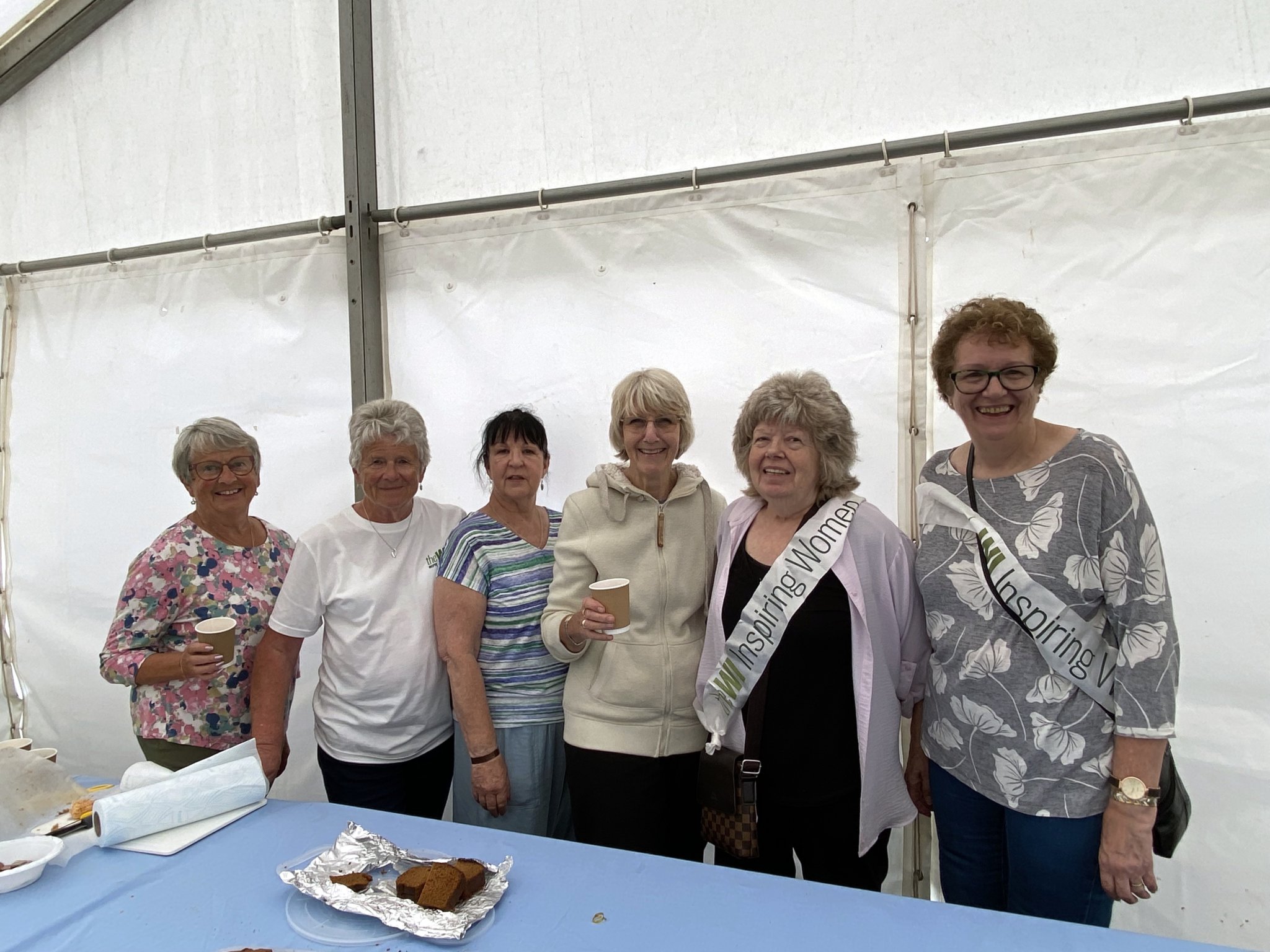 l-r Eileen Harris (Bude WI), Cynthia May (Bude WI), Sue Dyer (Week St Mary WI), Heather Stephenson (Bude WI), Rachel Roberts (Marhamchurch WI), Penny Hazeldine (Marhamchurch WI), had spent the day handing out refreshments and enlightening visitors on local WI activities during the show.