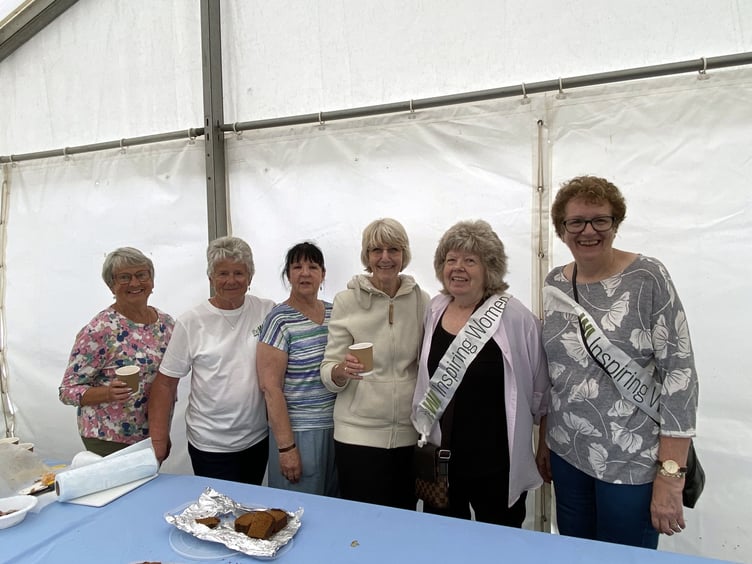 l-r Eileen Harris (Bude WI), Cynthia May (Bude WI), Sue Dyer (Week St Mary WI), Heather Stephenson (Bude WI), Rachel Roberts (Marhamchurch WI), Penny Hazeldine (Marhamchurch WI), had spent the day handing out refreshments and enlightening visitors on local WI activities during the show.