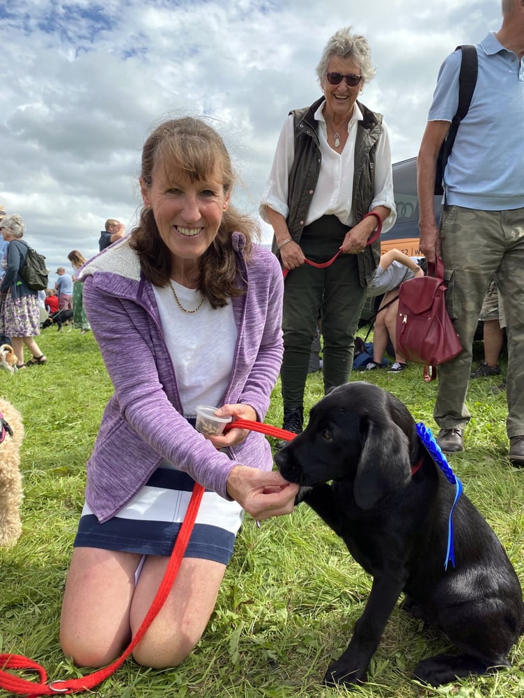 Jane Hynes from Launceston is pictured here with her 16 week old rescue black labrador, Deacon. The pair has just came first in the cutest puppy class in the dog show.