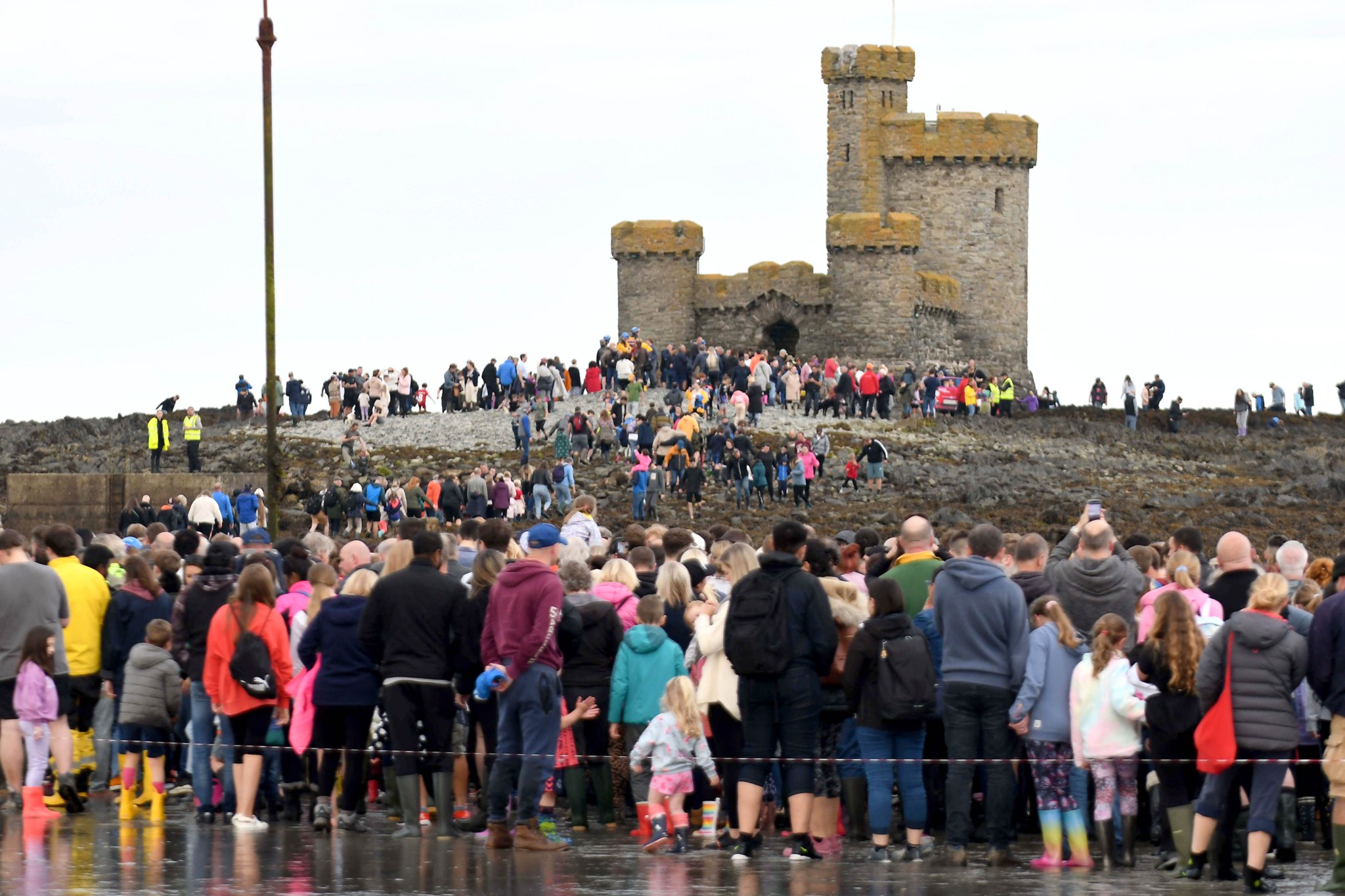 Thousands of people take part in a guided walk to the Tower of Refuge -