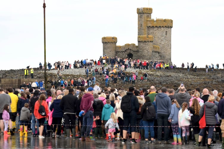 Thousands of people take part in a guided walk to the Tower of Refuge -