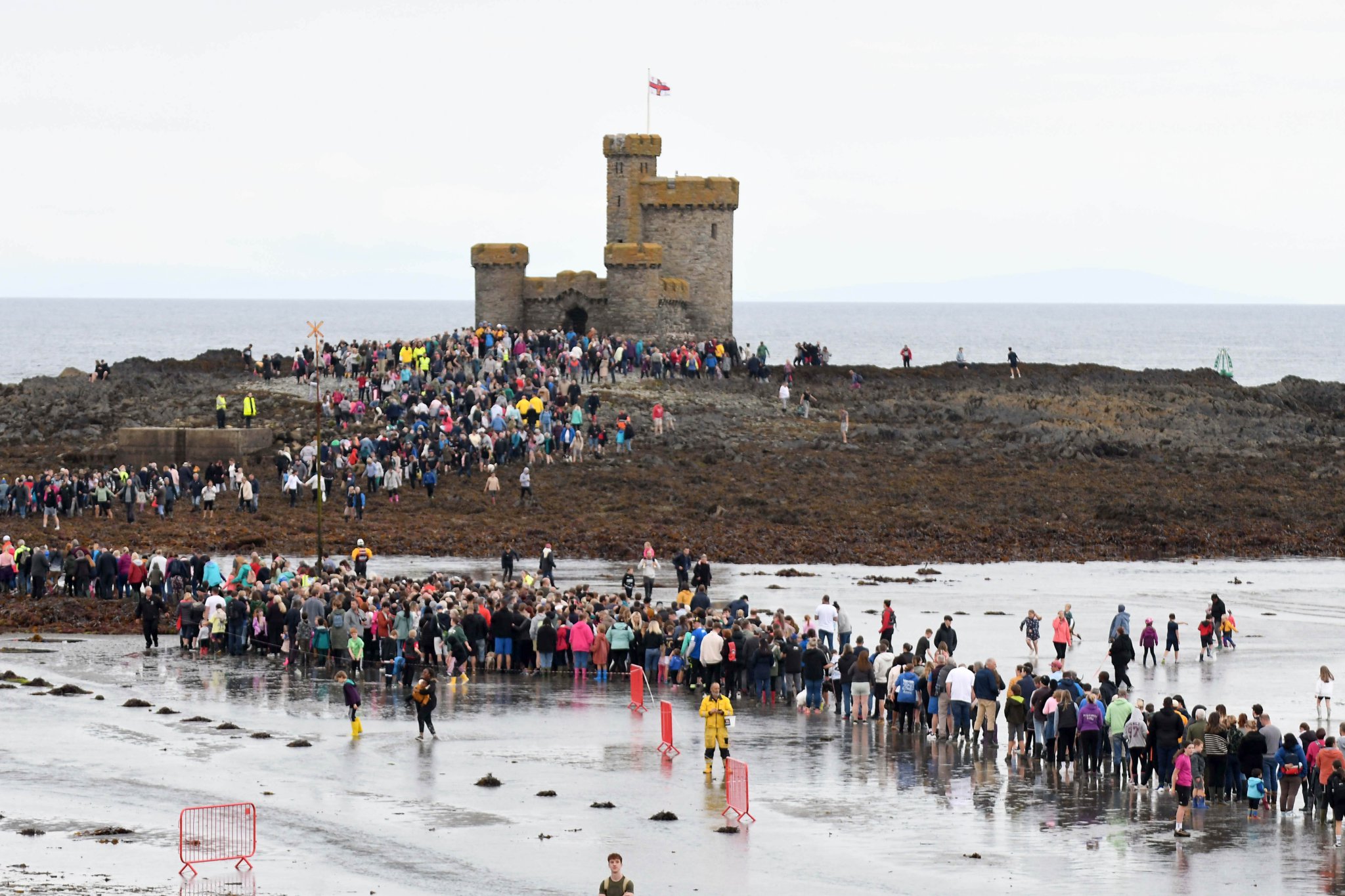 Thousands of people take part in a guided walk to the Tower of Refuge -