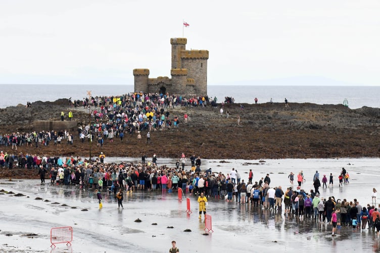 Thousands of people take part in a guided walk to the Tower of Refuge -