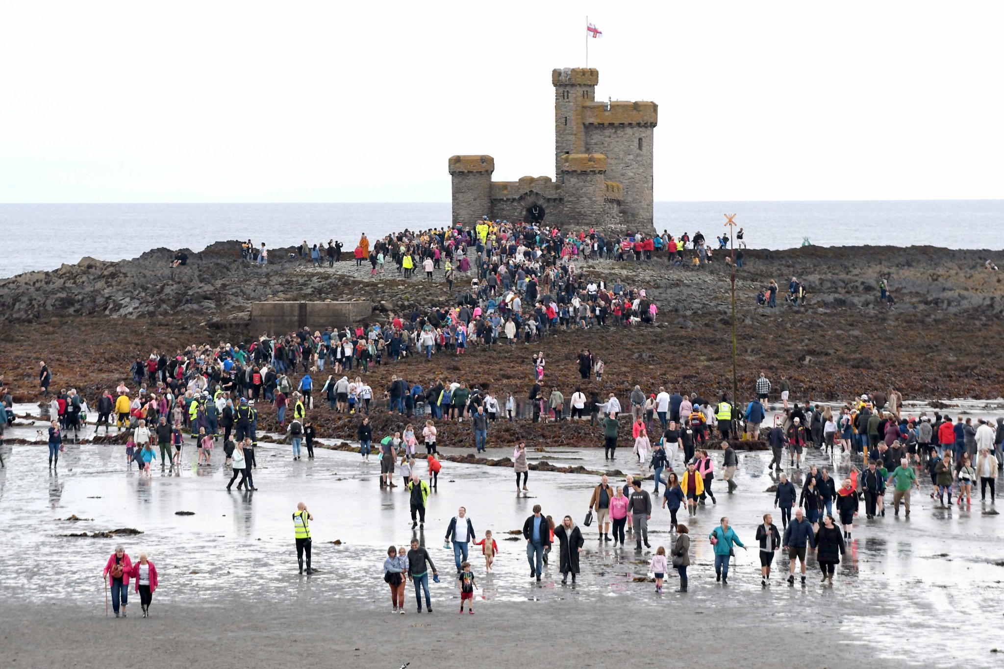 Thousands of people take part in a guided walk to the Tower of Refuge -